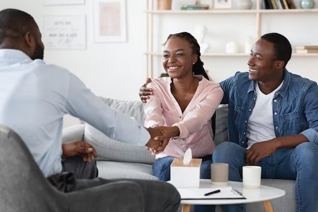 A group of people sitting around a living room.