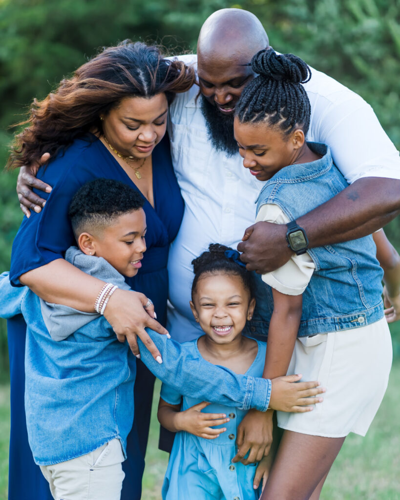 Black family hugging and happy