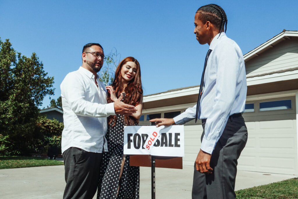 Man helping a couple purchase a home in a real estate deal